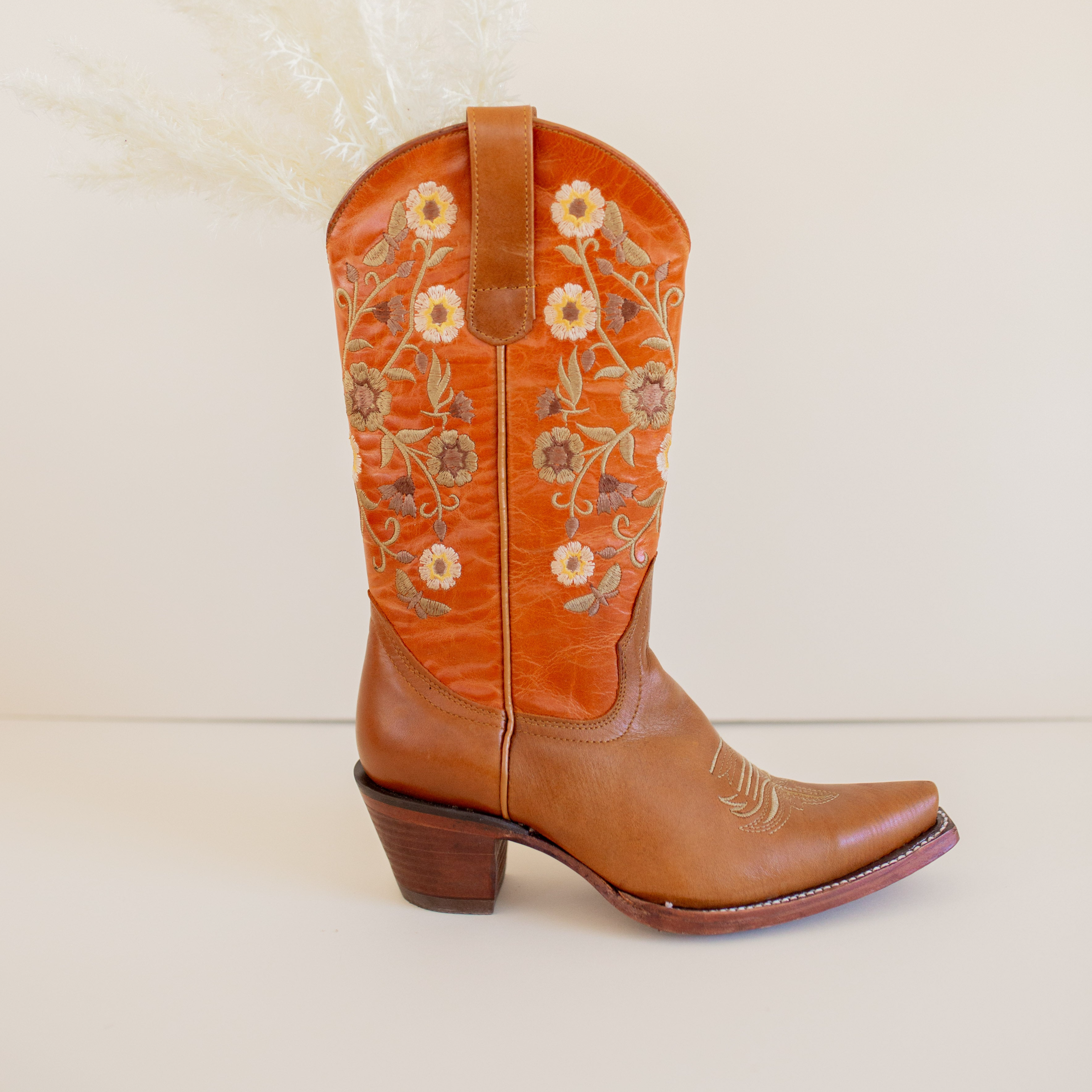 Marci Western Boot Embroidered Floral Pattern on tall Part, Reddish brown Top color, and a brown toe/foot part with a pointed toe