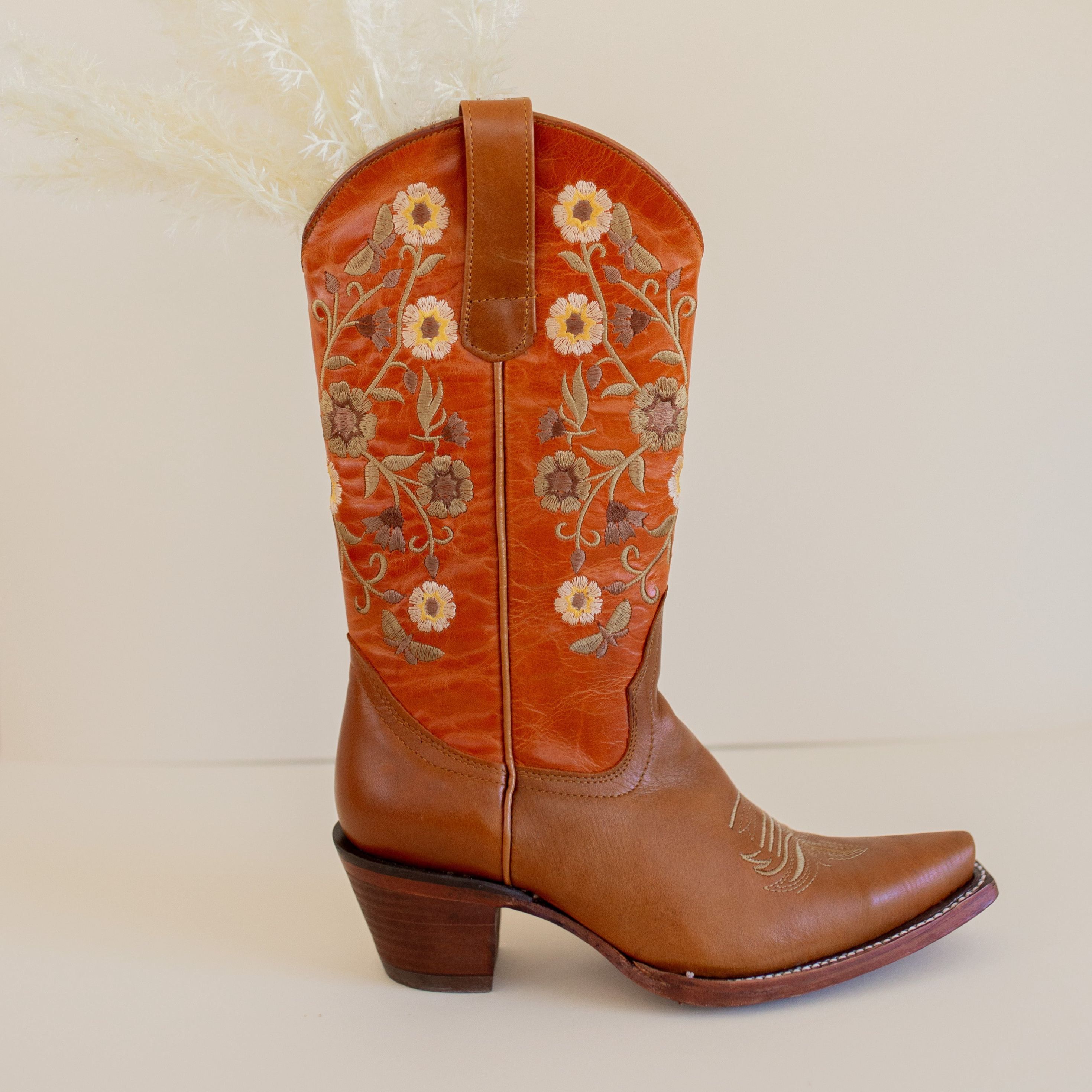 Marci Western Boot Embroidered Floral Pattern on tall Part, Reddish brown Top color, and a brown toe/foot part with a pointed toe