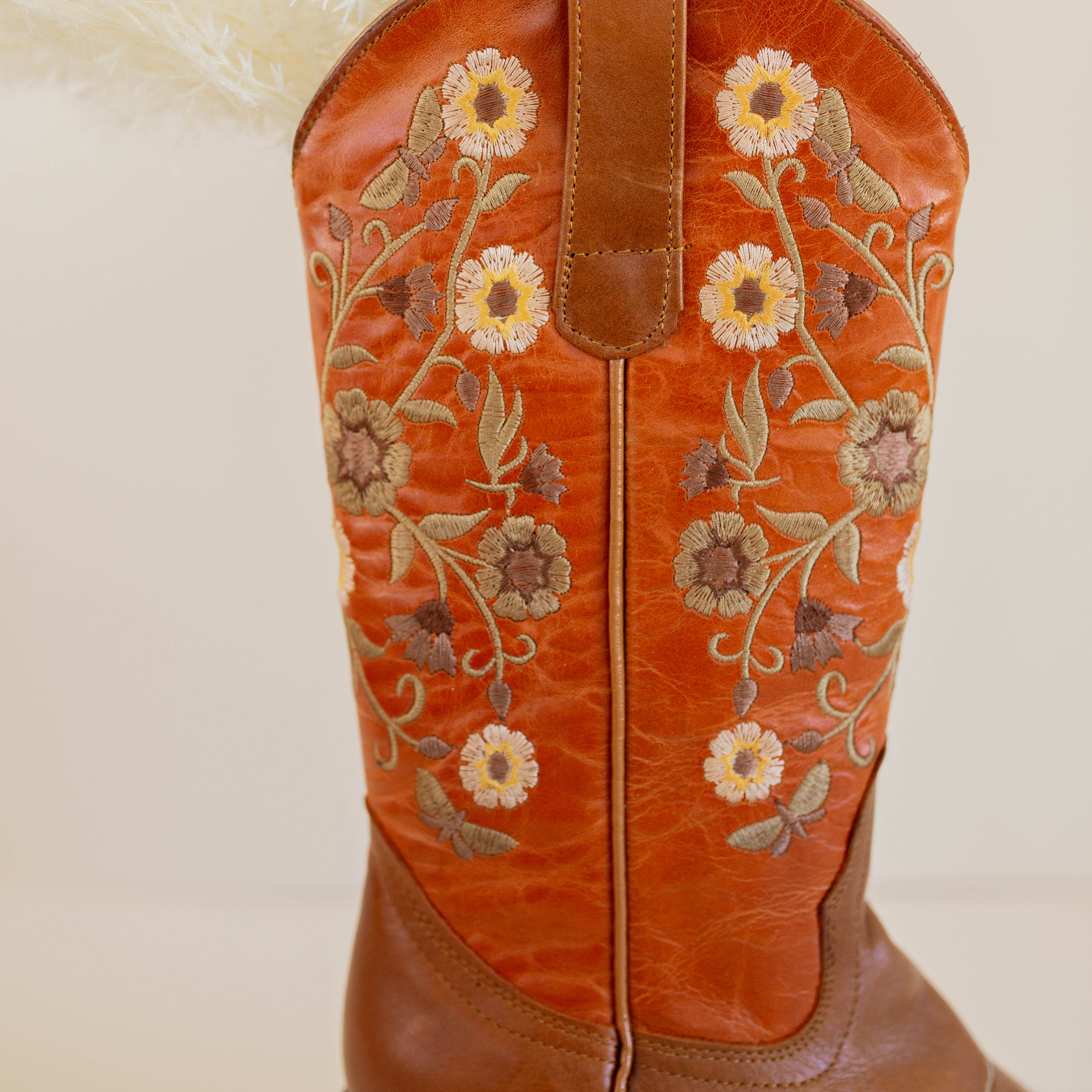 Marci Western Boot Embroidered Floral Pattern on tall Part, Reddish brown Top color, and a brown toe/foot part with a pointed toe